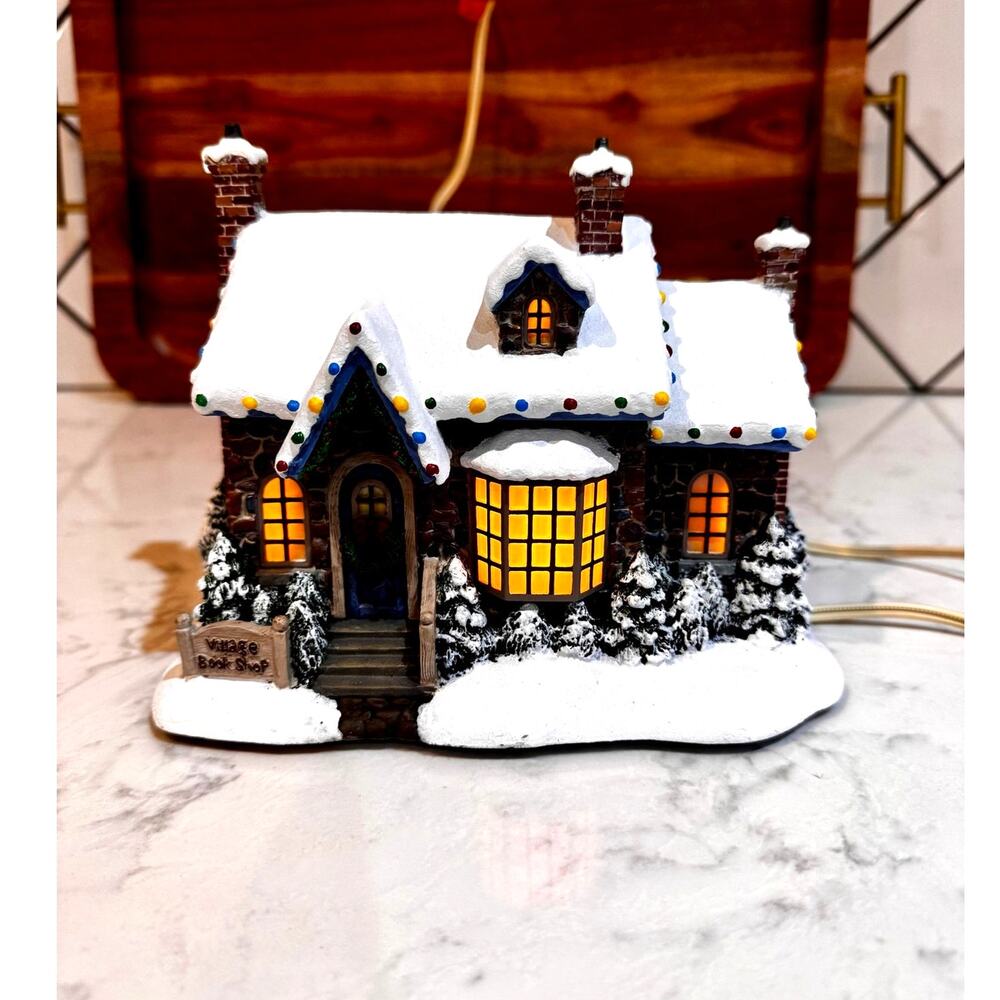 Thomas Kinkade's Village Christmas lighted Village Clothier
by Hawthorne Village